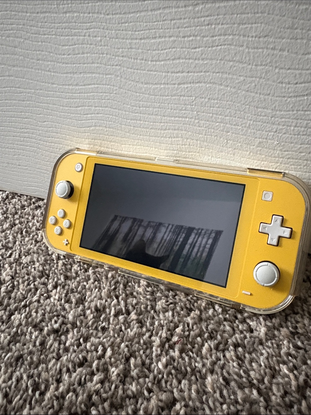 Yellow Nintendo Switch Lite, with grip case